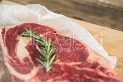 Sirloin chop and rosemary herb on wooden tray