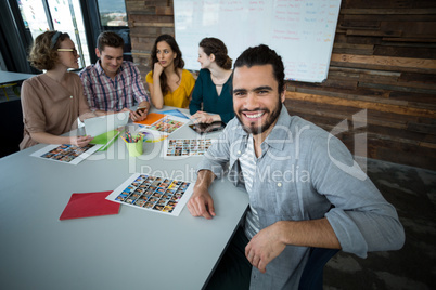 Portrait of smiling graphic designer sitting in office