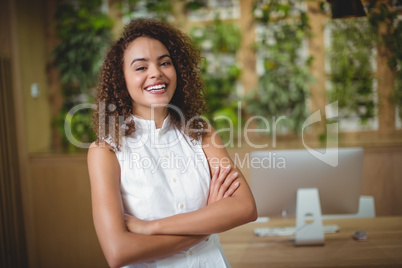 Female executive standing with arms crossed