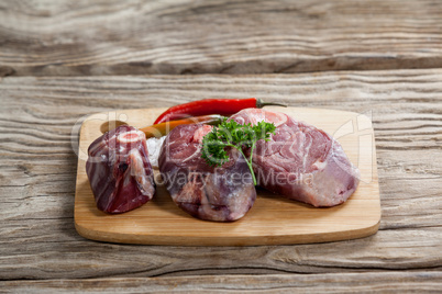 Sirloin chop, salt and chili on wooden board