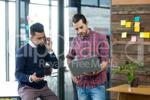 Business executives with laptop discussing on phone