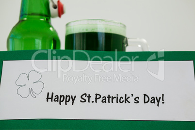 Mug of green beer and beer bottle for St Patricks Day