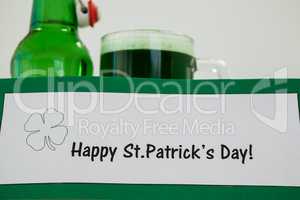 Mug of green beer and beer bottle for St Patricks Day