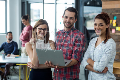 Businesspeople having discussion over laptop in office