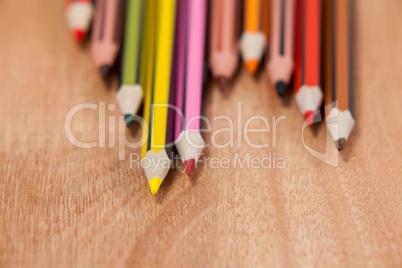 Close-up of colored pencils arranged in a wave pattern