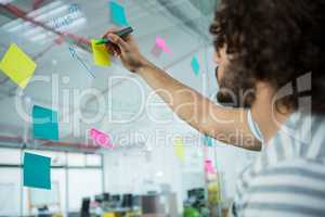 Executive writing on sticky notes
