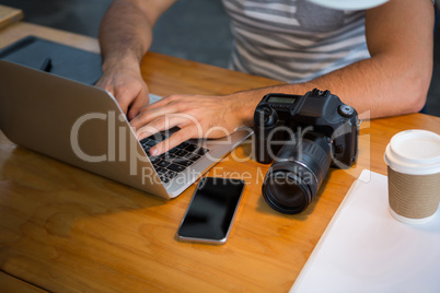 Graphic designer using laptop in creative office Graphic designer using laptop in creative office