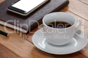Black coffee with organizer and mobile phone