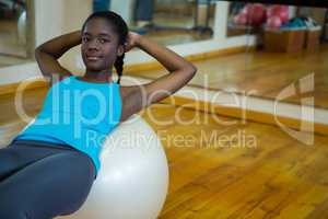 Portrait of fit woman exercising on fitness ball