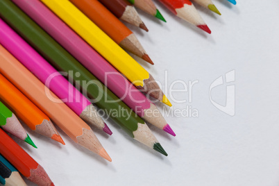 Close-up of colored pencils arranged in a wave pattern