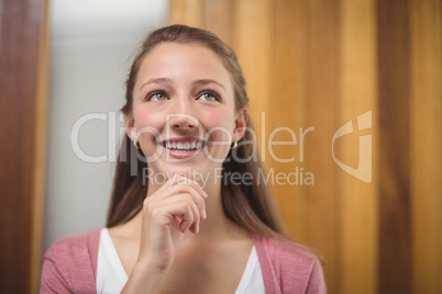 Thoughtful schoolgirl with hand on chin