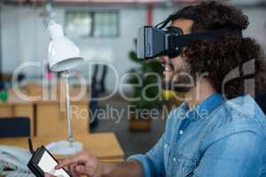 Graphic designer using the virtual reality headset and digital tablet