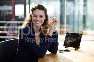 Portrait of businesswoman sitting at desk in office