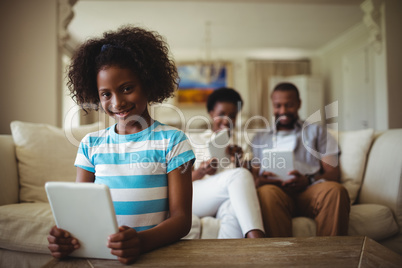 Family using digital tablet in living room