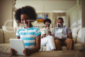 Family using digital tablet in living room