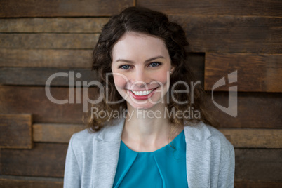 Smiling female business executive standing in office