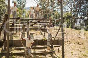 Military soldiers training rope climbing