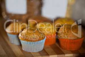 Close-up of cupcakes on wooden board