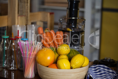 Juicer with carrot and lemon in a bowl