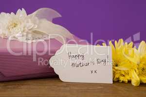 Happy mothers day card on gift box with flowers
