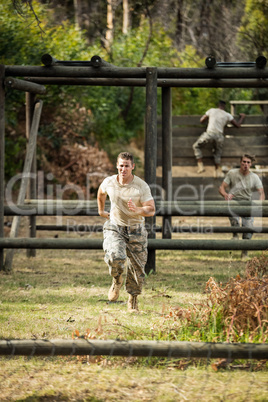 Soldier running through obstacle course