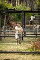 Soldier running through obstacle course