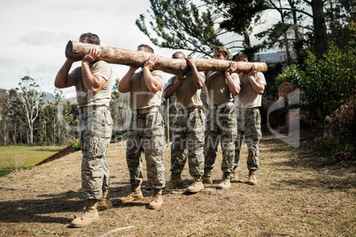 Soldiers carrying a tree log