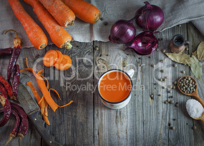Juice in a mug on a gray wooden surface