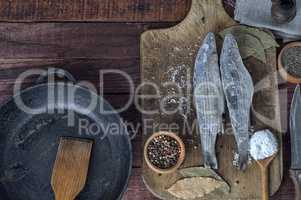 Frozen fish smelt on the kitchen board