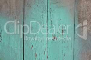 green wood texture with cracks on the paint and abrasions