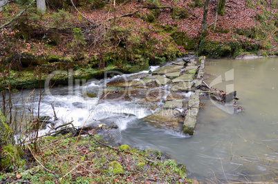 Small waterfall on a stone dam