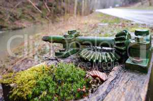 Old green gear on a small wooden