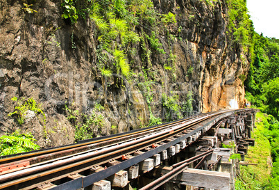 Dead railway beside cliff, along Kwai river in Thailand