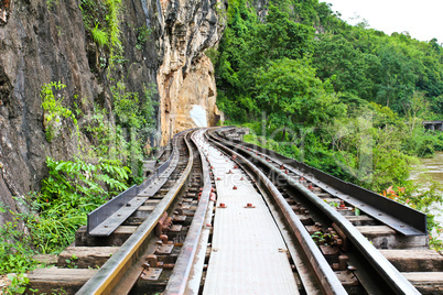 Dead railway beside cliff, along Kwai river in Thailand