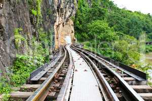Dead railway beside cliff, along Kwai river in Thailand