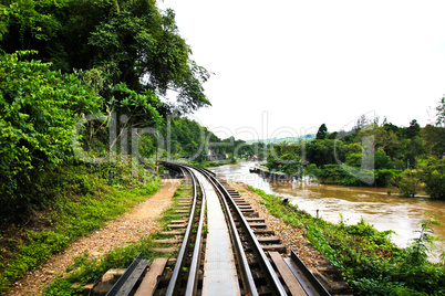 Dead railway beside cliff, along Kwai river in Thailand