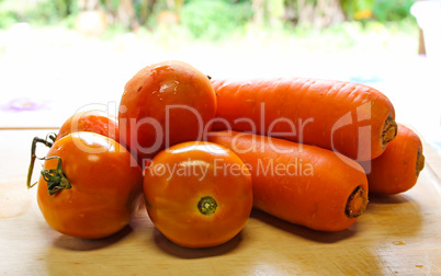 Tomatoes and carrots on a cutting board