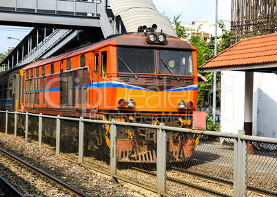 Red orange train, Diesel locomotive, on Bangkok railway station