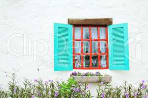 Decorative vintage window with colorful plants.