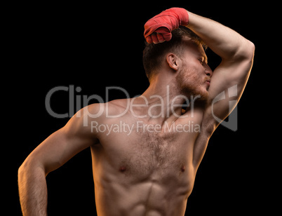 Muscular man kissing biceps