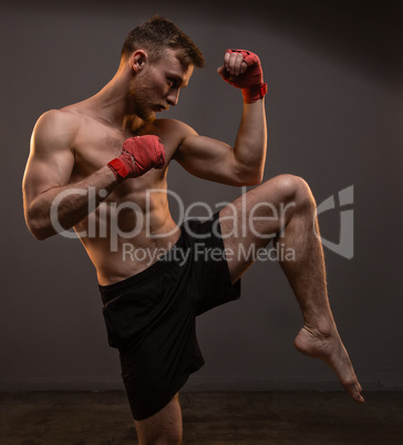 Muscular blond man with leg up