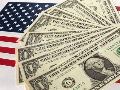 Dollar notes and flag of the United States