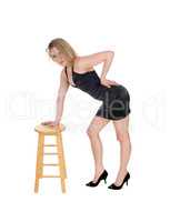 Woman standing on chair.