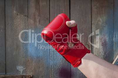 Man's hand in red boxing gloves
