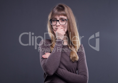 Thoughtful teenage girl in glasses