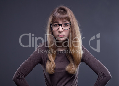 Skeptical young girl in glasses
