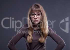 Skeptical young girl in glasses