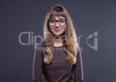 Smiling teenage girl in glasses