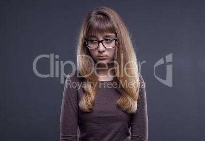 Offended teenage girl in glasses