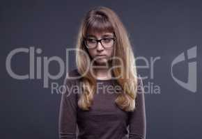 Offended teenage girl in glasses